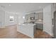 An open-concept kitchen with island, stainless appliances, and seamless living space at 14028 Parkside Crossing Dr # 331, Charlotte, NC 28273