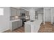 Well-appointed kitchen featuring gray cabinets, stainless steel appliances, and a center island with sink at 14028 Parkside Crossing Dr # 331, Charlotte, NC 28273