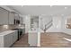 Open kitchen with gray cabinets, an island, hardwood floors, and stainless steel appliances at 14028 Parkside Crossing Dr # 331, Charlotte, NC 28273