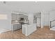 Modern kitchen with gray cabinets, stainless steel appliances, a center island, and hardwood floors at 14028 Parkside Crossing Dr # 331, Charlotte, NC 28273