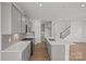 Stylish kitchen with gray cabinetry, quartz counters, stainless appliances, island, and wood flooring at 14028 Parkside Crossing Dr # 331, Charlotte, NC 28273