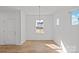Bright living room with wood floors, modern lighting, and natural light at 14028 Parkside Crossing Dr # 331, Charlotte, NC 28273