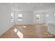 Open-concept living room with hardwood floors, large windows, and natural light, perfect for entertaining at 14028 Parkside Crossing Dr # 331, Charlotte, NC 28273