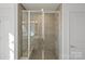 Modern glass-enclosed shower with tile surround and built-in seating at 14028 Parkside Crossing Dr # 331, Charlotte, NC 28273