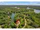 Stunning aerial view of a waterfront property nestled among mature trees on a picturesque lake at 141 Ridge Top Rd, Mooresville, NC 28117
