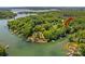 Aerial view of a lakefront home surrounded by lush greenery, offering serene waterfront living at 141 Ridge Top Rd, Mooresville, NC 28117