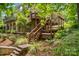 Multi-tiered deck with access to the home's lush backyard with a stone retaining wall at 141 Ridge Top Rd, Mooresville, NC 28117