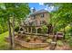 Spacious backyard featuring multiple levels of outdoor living space and mature trees at 141 Ridge Top Rd, Mooresville, NC 28117