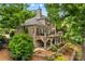 Multi-level patio and landscaped backyard of brick home, perfect for outdoor entertaining at 141 Ridge Top Rd, Mooresville, NC 28117