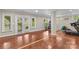 Finished basement area with wood floors, fitness equipment, and a walkout to the exterior at 141 Ridge Top Rd, Mooresville, NC 28117