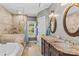 Bathroom boasts double sink vanity, soaking tub, and shower with decorative tile surround at 141 Ridge Top Rd, Mooresville, NC 28117