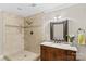 Bathroom with a tiled shower, a vanity, an accent mirror, and tile flooring at 141 Ridge Top Rd, Mooresville, NC 28117