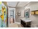 Well-lit bathroom with a marble vanity, ceramic floors, and an adjacent room at 141 Ridge Top Rd, Mooresville, NC 28117