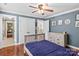 A bedroom with hardwood floors, blue walls, a ceiling fan and white trim at 141 Ridge Top Rd, Mooresville, NC 28117