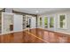 Bedroom with reclaimed wood accent wall, hardwood floors, and access to a bathroom at 141 Ridge Top Rd, Mooresville, NC 28117