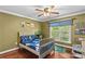 Bedroom features hardwood floors, ceiling fan, a large window, and ample closet space at 141 Ridge Top Rd, Mooresville, NC 28117