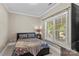 Neutral bedroom with floral bedding, natural light, and a side table at 141 Ridge Top Rd, Mooresville, NC 28117