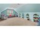 Spacious bonus room with built-in shelves, plush carpeting, and a cozy seating area at 141 Ridge Top Rd, Mooresville, NC 28117