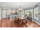 Open dining area features wood table with bench seating and views from many windows that bring in natural light at 141 Ridge Top Rd, Mooresville, NC 28117