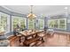 Charming dining room with large windows, a farmhouse table, and a stylish chandelier, ideal for Gathering meals at 141 Ridge Top Rd, Mooresville, NC 28117