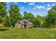 Stately brick home with a meticulously manicured lawn and mature trees offering shade and privacy at 141 Ridge Top Rd, Mooresville, NC 28117