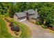 Brick house featuring an attached garage and beautiful landscaping along the driveway at 141 Ridge Top Rd, Mooresville, NC 28117