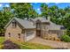 Beautiful stone and brick home featuring a well-manicured lawn and attached two car garage at 141 Ridge Top Rd, Mooresville, NC 28117