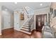 Inviting foyer with hardwood floors, elegant staircase, and stylish decor, offering a warm welcome at 141 Ridge Top Rd, Mooresville, NC 28117