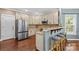 Modern kitchen with stainless steel appliances, granite countertops, and a breakfast bar, perfect for casual dining at 141 Ridge Top Rd, Mooresville, NC 28117