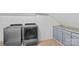 Bright laundry room with new appliances, tile floor, and counter space at 141 Ridge Top Rd, Mooresville, NC 28117