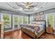 This main bedroom offers lots of natural light, a ceiling fan, and tray ceiling at 141 Ridge Top Rd, Mooresville, NC 28117