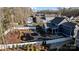 Overhead image showcases a home's backyard, featuring intricate landscaping, fire pit, and perimeter fencing at 1502 Matthew Mcclure Cir, Davidson, NC 28036
