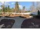 Landscaped backyard features a decorative stone path and lush greenery for a tranquil outdoor space at 1502 Matthew Mcclure Cir, Davidson, NC 28036