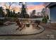 Backyard fire pit with Adirondack chairs is perfect for relaxing evenings at 1502 Matthew Mcclure Cir, Davidson, NC 28036