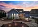 Landscaped backyard featuring a fire pit area, mature trees, and an inviting outdoor living space at 1502 Matthew Mcclure Cir, Davidson, NC 28036