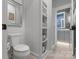 Bright bathroom featuring a toilet and built-in shelves for storage and a view of the elegant vanity at 1502 Matthew Mcclure Cir, Davidson, NC 28036