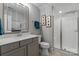 Elegant bathroom featuring a glass-enclosed shower, a marble vanity, and modern fixtures and decor at 1502 Matthew Mcclure Cir, Davidson, NC 28036