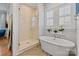 Luxurious bathroom with a soaking tub, glass shower, and bright windows at 1502 Matthew Mcclure Cir, Davidson, NC 28036