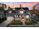 Charming two-story home featuring a welcoming front porch, solar panels, and well-maintained landscaping at 1502 Matthew Mcclure Cir, Davidson, NC 28036