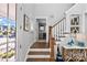 Inviting foyer with hardwood staircase, stylish decor, and an open view to a hallway and bathroom at 1502 Matthew Mcclure Cir, Davidson, NC 28036