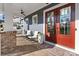 Relaxing front porch view showcasing a seating area, ceiling fan, and brick accents at 1502 Matthew Mcclure Cir, Davidson, NC 28036