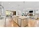 Open-concept kitchen island leading to the living room and dining area at 1502 Matthew Mcclure Cir, Davidson, NC 28036