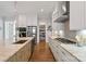 Well-lit kitchen featuring stainless steel appliances, an island, and white cabinetry at 1502 Matthew Mcclure Cir, Davidson, NC 28036