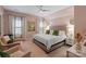 Charming bedroom with soft pink walls, large bed, and lots of natural light creating a serene retreat at 1502 Matthew Mcclure Cir, Davidson, NC 28036