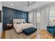 Luxurious bedroom with blue accent wall, plush bedding, and natural light at 1502 Matthew Mcclure Cir, Davidson, NC 28036