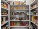 Organized walk-in pantry with shelves stocked with various food items at 1502 Matthew Mcclure Cir, Davidson, NC 28036