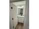 Bright bathroom features white cabinets, granite countertop, modern lighting, and wood-look flooring at 1563 Riverview Cir, Fort Lawn, SC 29714
