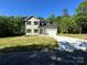 Charming two-story home with a well-manicured lawn, attached garage, and classic architectural details at 1563 Riverview Cir, Fort Lawn, SC 29714