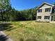 New home with a spacious front yard, lush greenery, and dark shutters on the windows at 1563 Riverview Cir, Fort Lawn, SC 29714