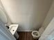 Modern half bathroom with a pedestal sink, round mirror, and toilet at 1563 Riverview Cir, Fort Lawn, SC 29714